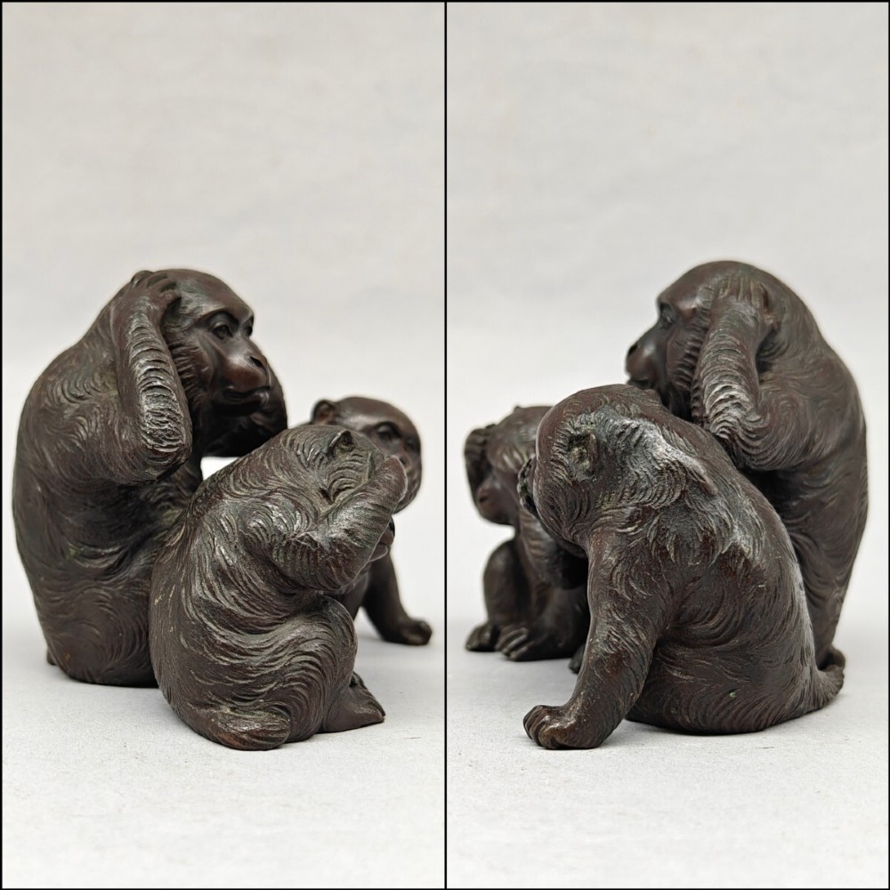 A patinated dark bronze sculpture depicting three monkeys seated together representing the motif of see no evil, hear no evil, and speak no evil. View VIII