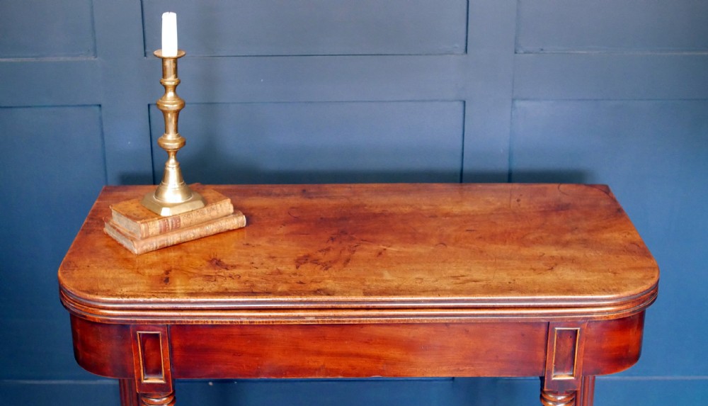 A nineteenth-century William IV mahogany fold-over tea table featuring reeded turned legs and a polished timber surface. View III