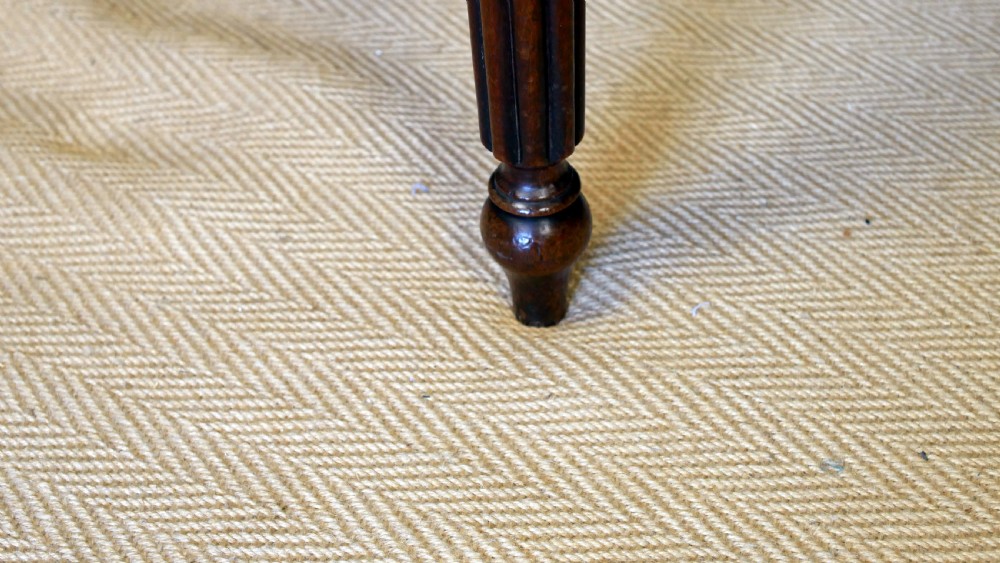 A nineteenth-century William IV mahogany fold-over tea table featuring reeded turned legs and a polished timber surface. View VI