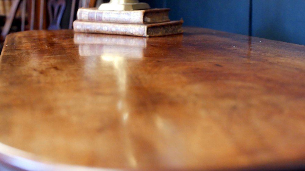 A nineteenth-century William IV mahogany fold-over tea table featuring reeded turned legs and a polished timber surface. View XVI