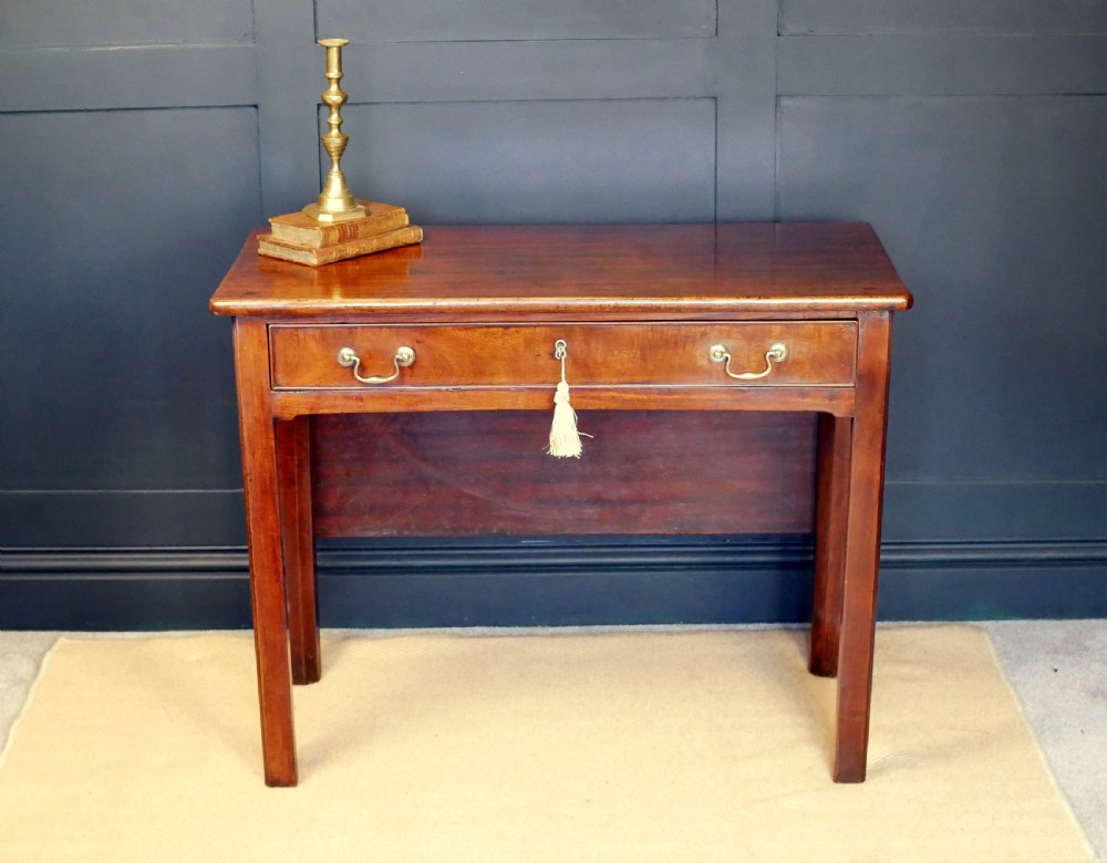 A George IV mahogany console table with a single frieze drawer, brass swan-neck handles, key tassel, and straight square legs. View II