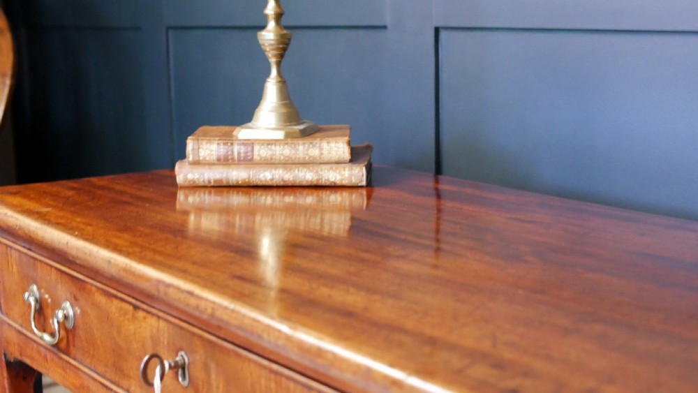 A George IV mahogany console table with a single frieze drawer, brass swan-neck handles, key tassel, and straight square legs. View VIII