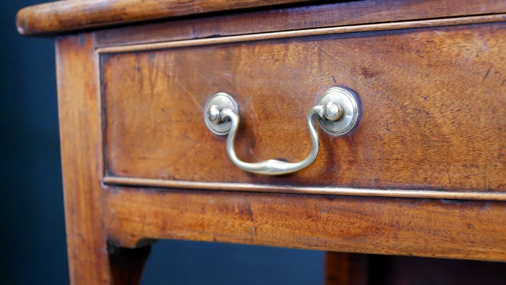 A George IV mahogany console table with a single frieze drawer, brass swan-neck handles, key tassel, and straight square legs. View XI
