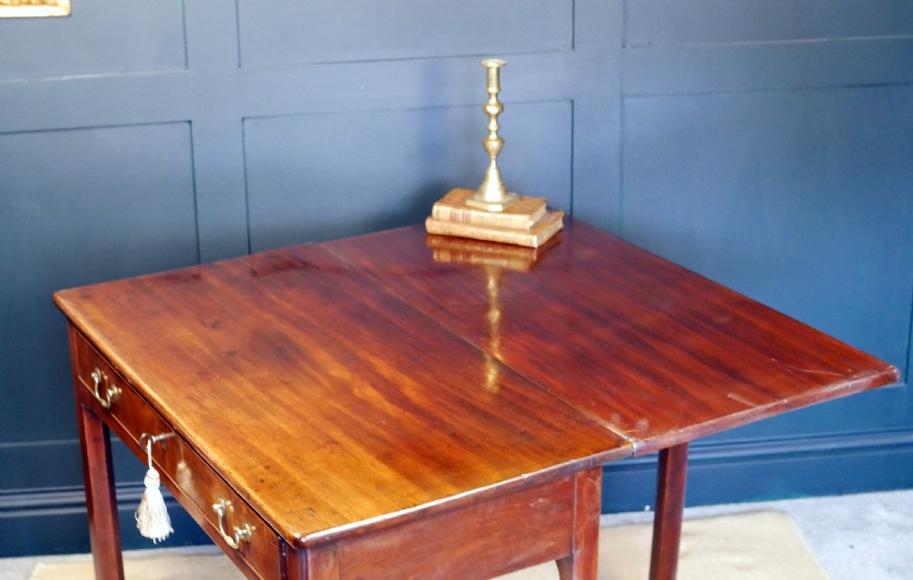 A George IV mahogany console table with a single frieze drawer, brass swan-neck handles, key tassel, and straight square legs. View XIII