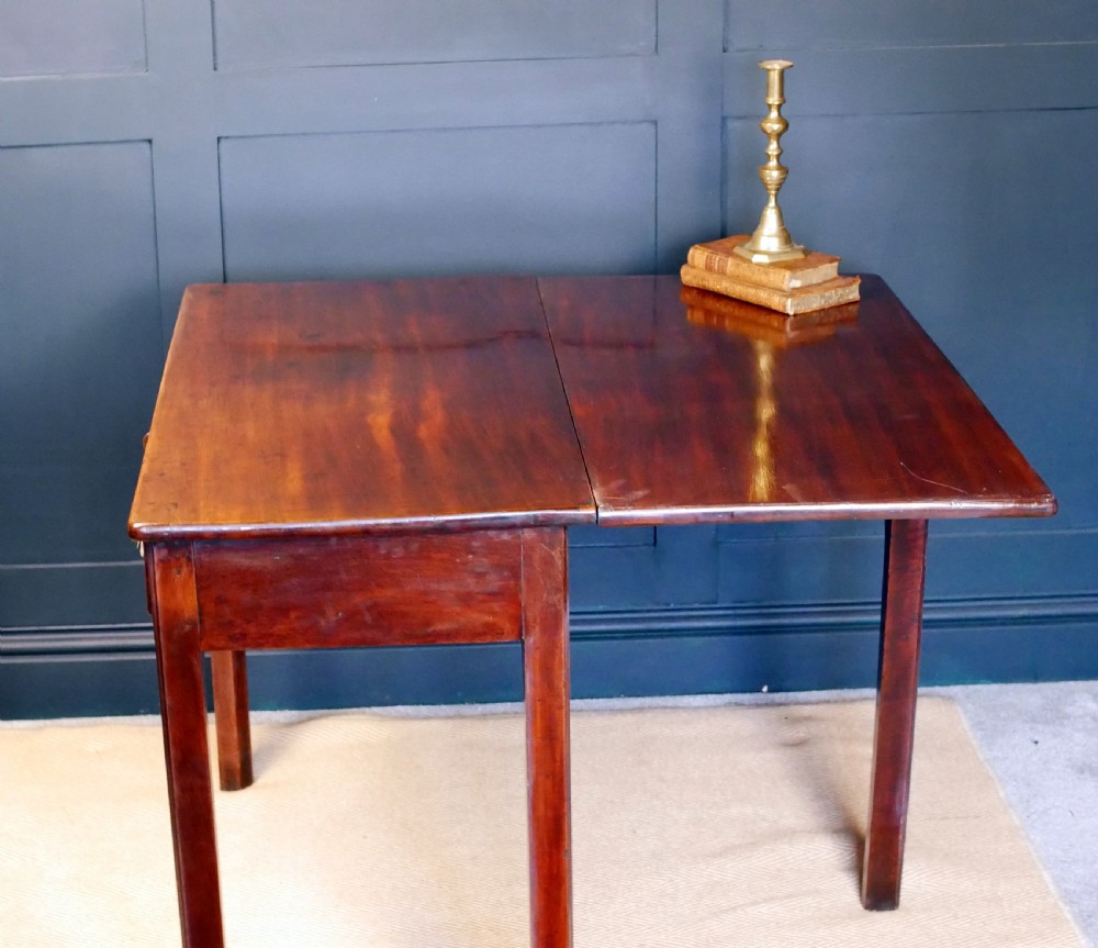 A George IV mahogany console table with a single frieze drawer, brass swan-neck handles, key tassel, and straight square legs. View XIV