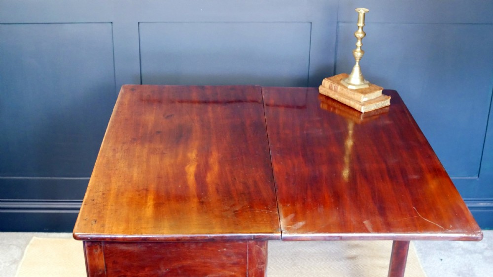 A George IV mahogany console table with a single frieze drawer, brass swan-neck handles, key tassel, and straight square legs. View XV