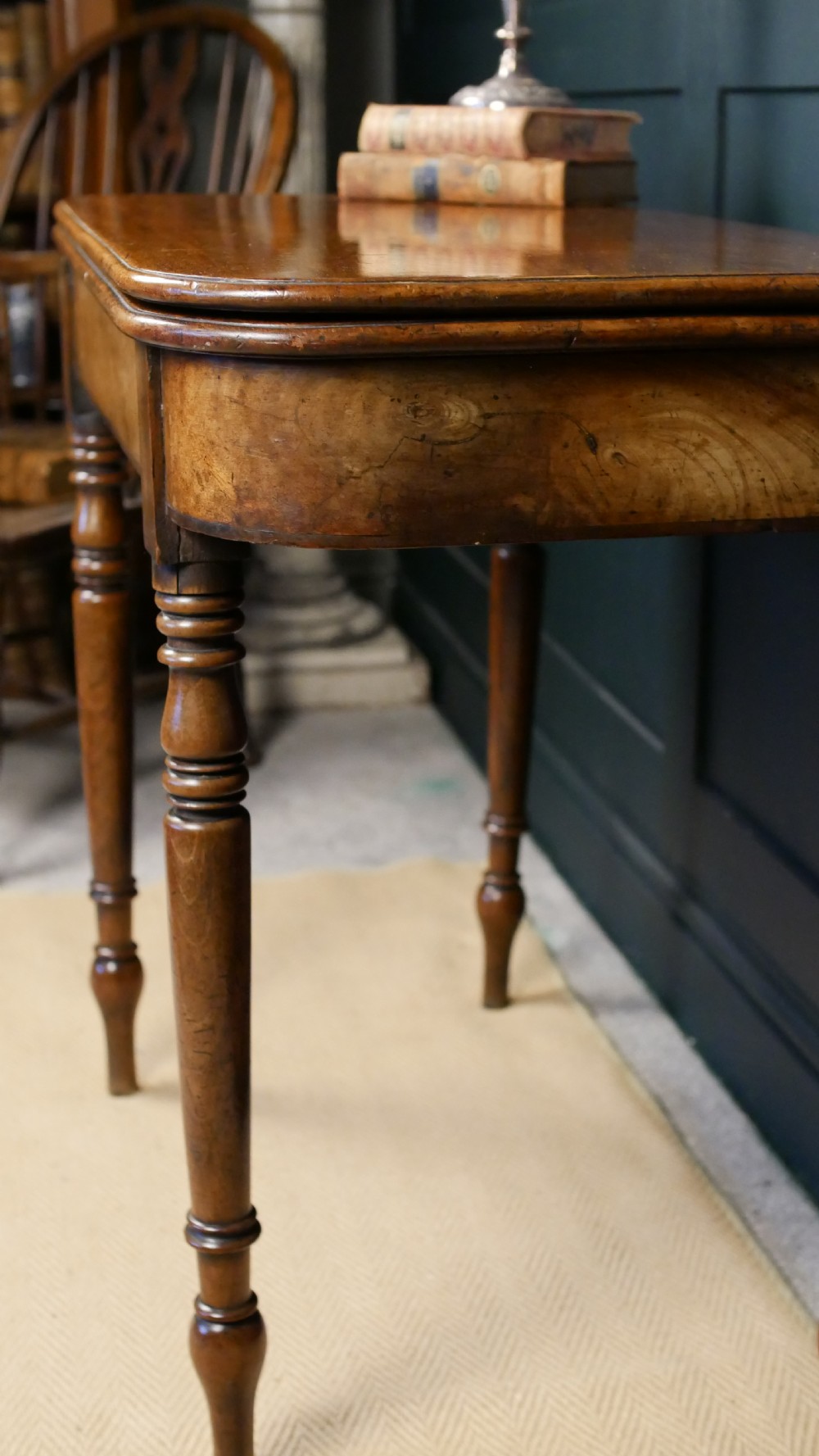 A Regency mahogany fold-over tea table featuring a rectangular hinged top with rounded corners, a deep frieze, and turned tapered legs. View XVIII