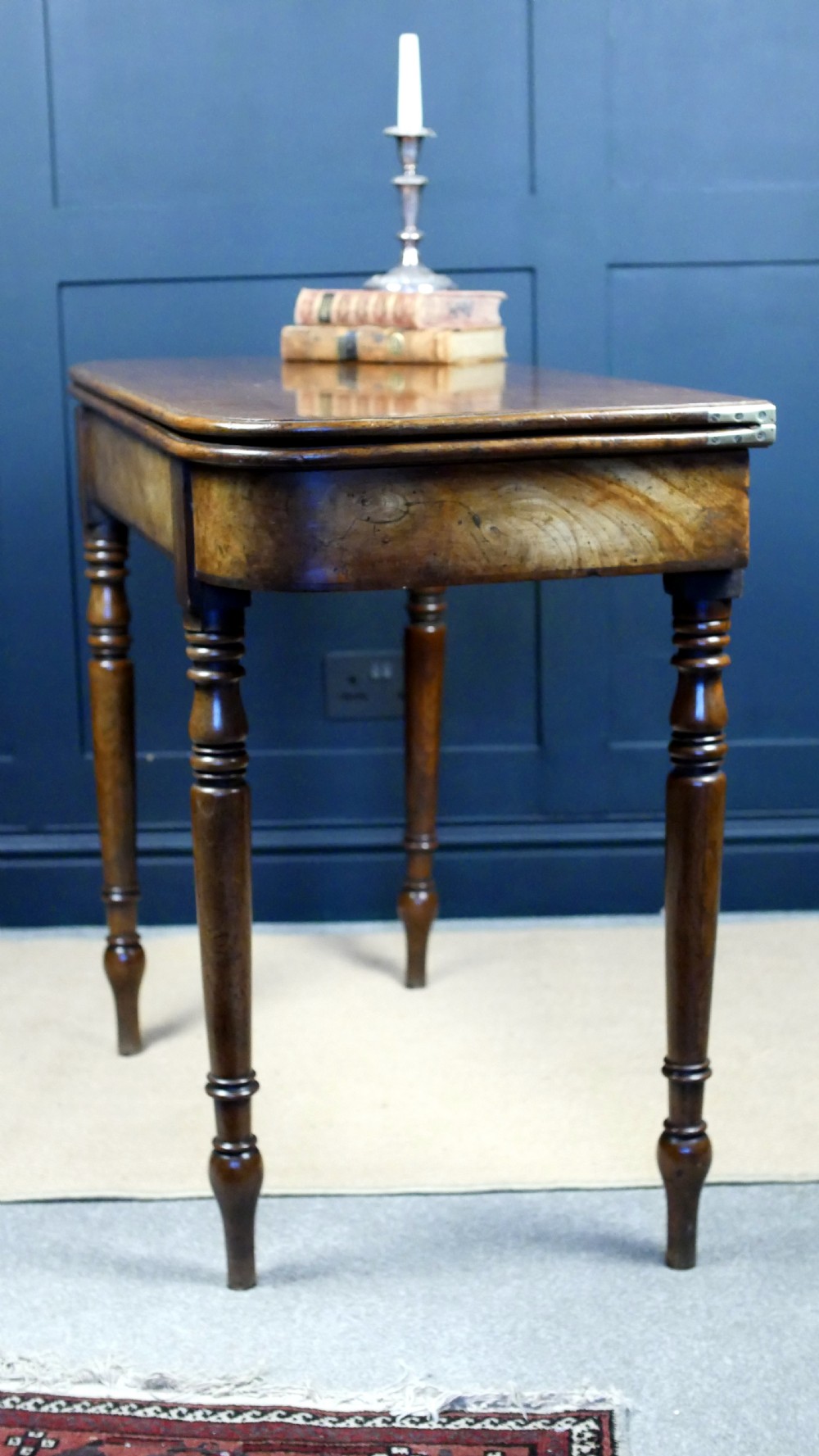 A Regency mahogany fold-over tea table featuring a rectangular hinged top with rounded corners, a deep frieze, and turned tapered legs. View XIX