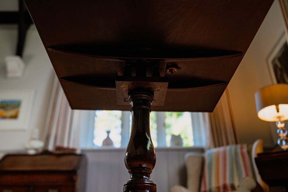 A Georgian mahogany tripod wine table featuring a circular top, turned column stem, and three cabriole legs. View IV