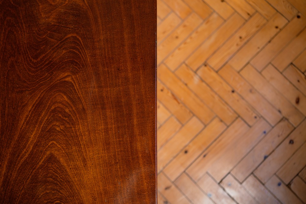 A Georgian mahogany tripod wine table featuring a circular top, turned column stem, and three cabriole legs. View V