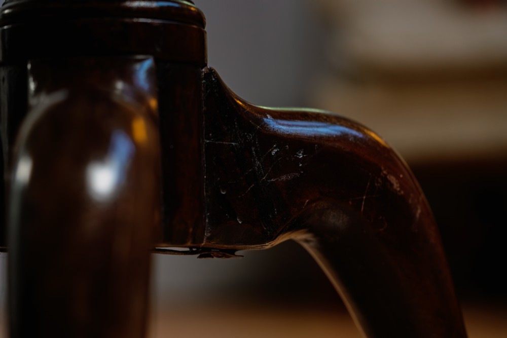 A Georgian mahogany tripod wine table featuring a circular top, turned column stem, and three cabriole legs. View VII