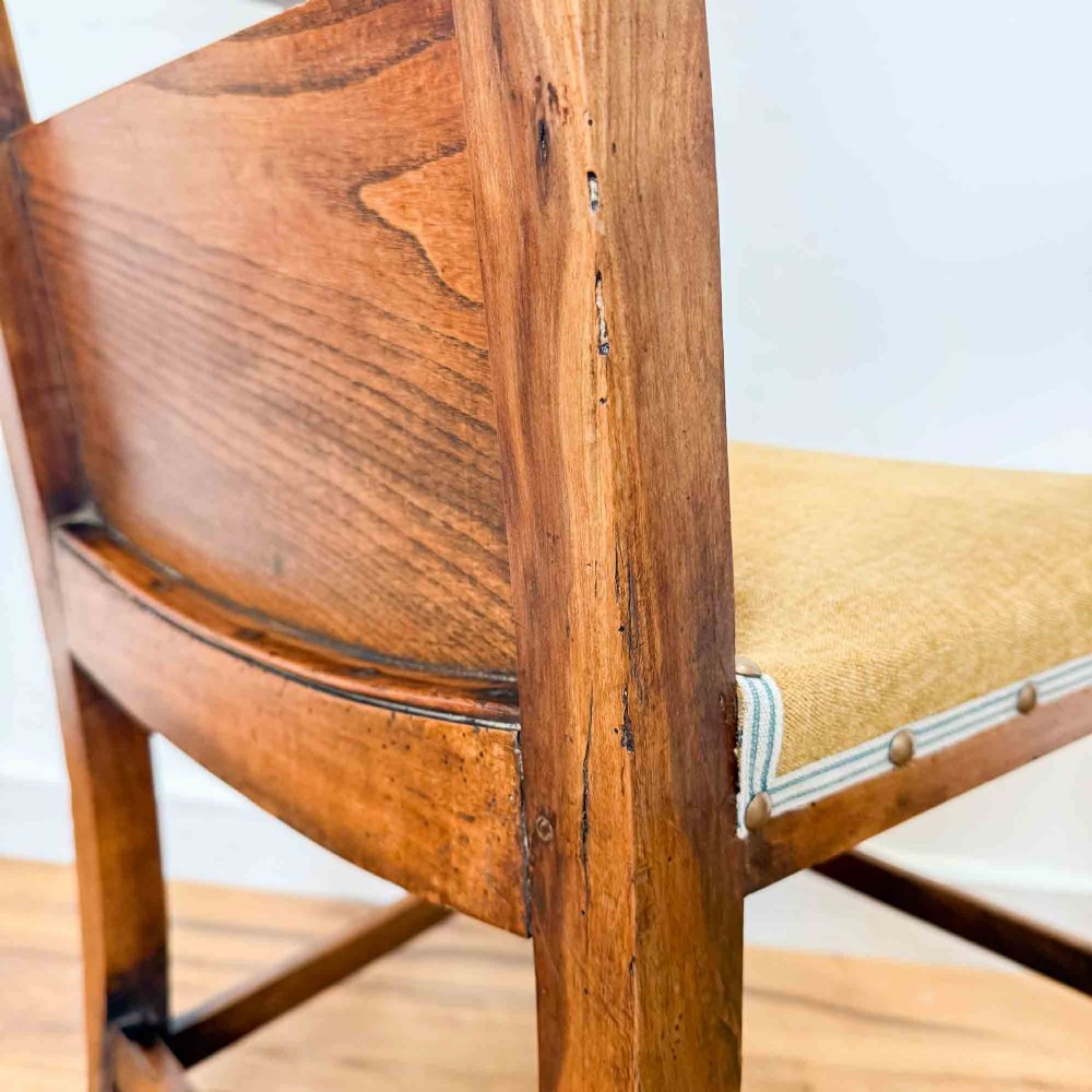 A Regency period high back open armchair crafted from fruitwood and elm with turned arm supports and a textured ochre upholstered seat. View VI