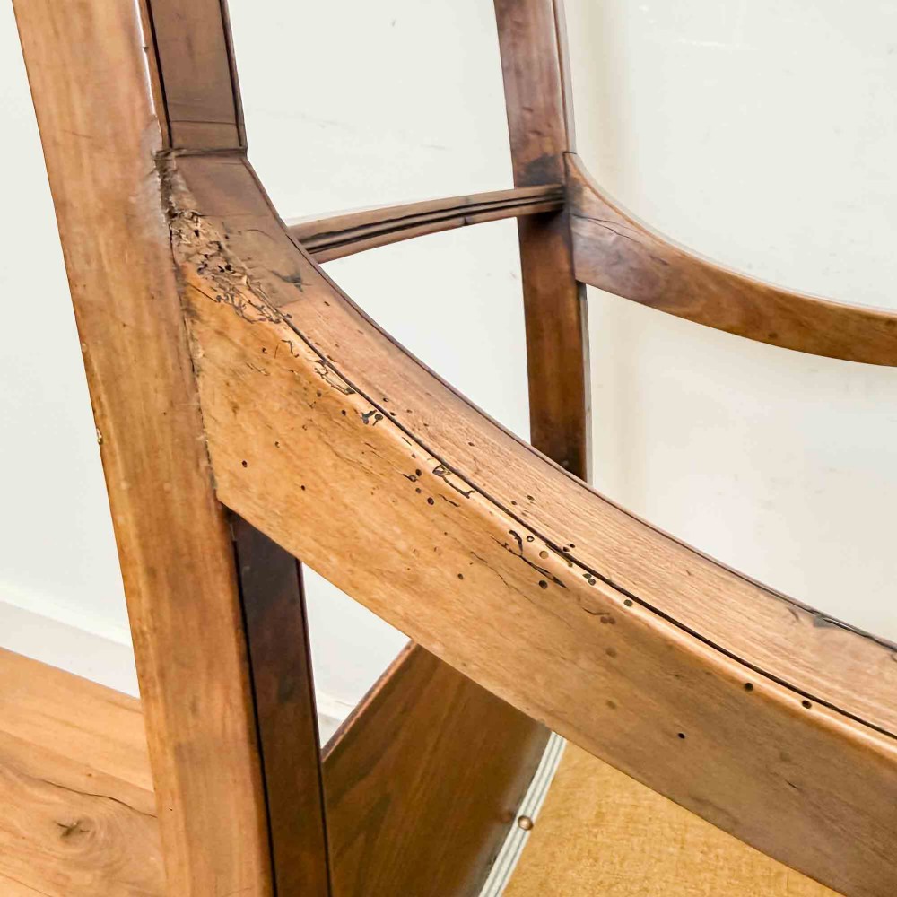 A Regency period high back open armchair crafted from fruitwood and elm with turned arm supports and a textured ochre upholstered seat. View VII