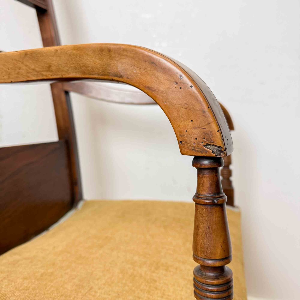 A Regency period high back open armchair crafted from fruitwood and elm with turned arm supports and a textured ochre upholstered seat. View VIII