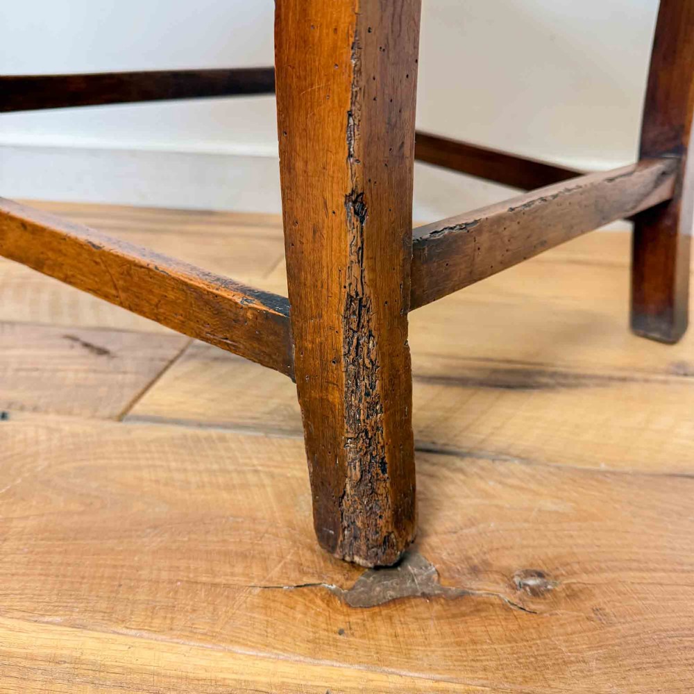 A Regency period high back open armchair crafted from fruitwood and elm with turned arm supports and a textured ochre upholstered seat. View XIII