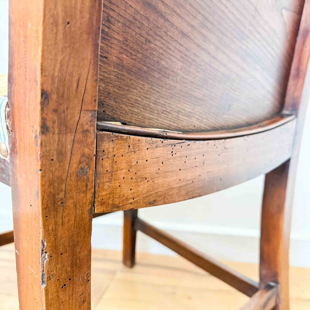 A Regency period high back open armchair crafted from fruitwood and elm with turned arm supports and a textured ochre upholstered seat. View XIV