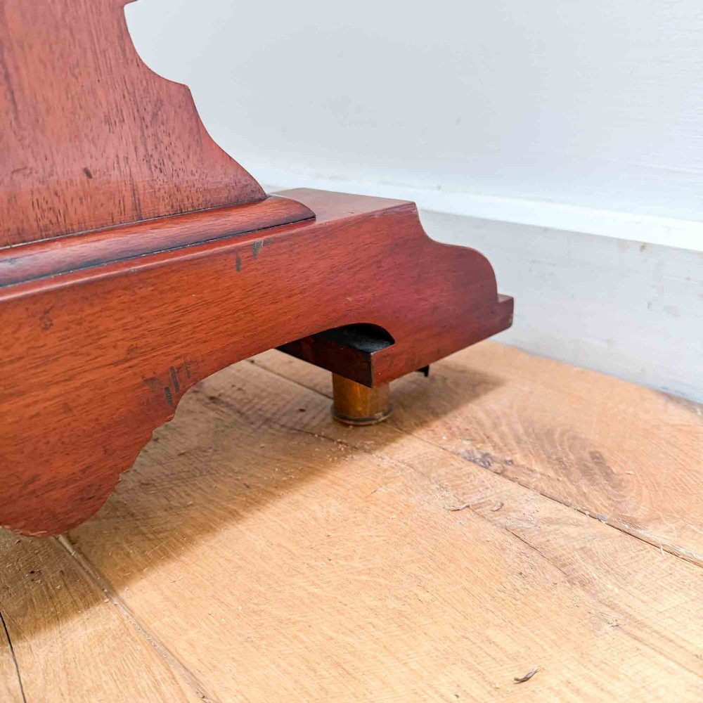 A Victorian mahogany writing table featuring a raised gallery back, two drawer fronts with wooden knobs, shaped lyre supports, and a low stretcher base on castors. View IX