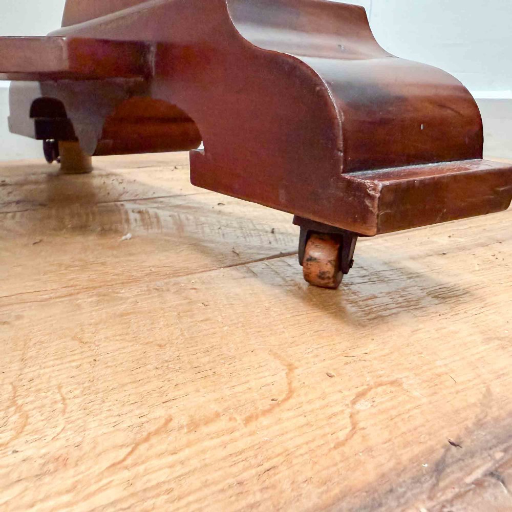 A Victorian mahogany writing table featuring a raised gallery back, two drawer fronts with wooden knobs, shaped lyre supports, and a low stretcher base on castors. View X