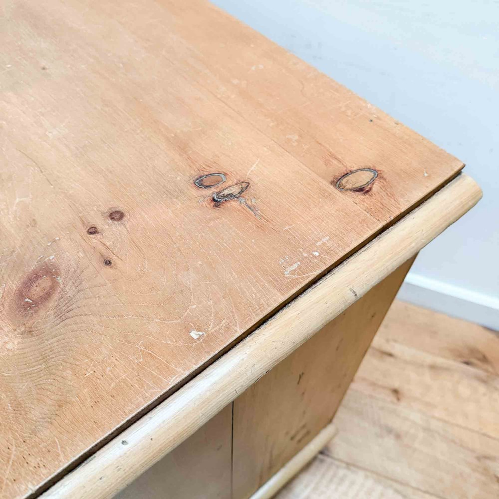 A natural light pine chest of drawers featuring three full-width drawers with turned wooden knobs, rounded front column edges, and turned bun feet. View V