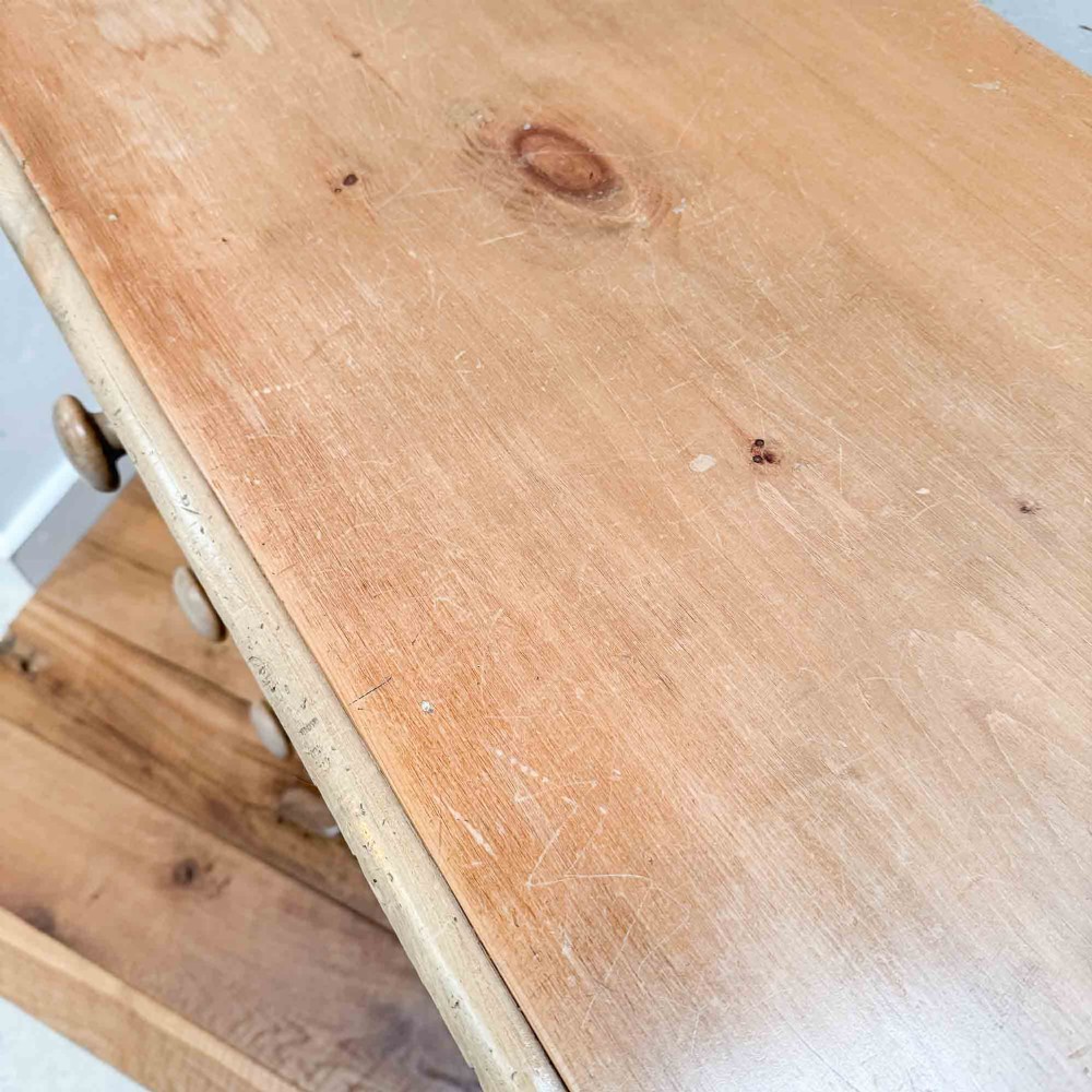 A natural light pine chest of drawers featuring three full-width drawers with turned wooden knobs, rounded front column edges, and turned bun feet. View VI