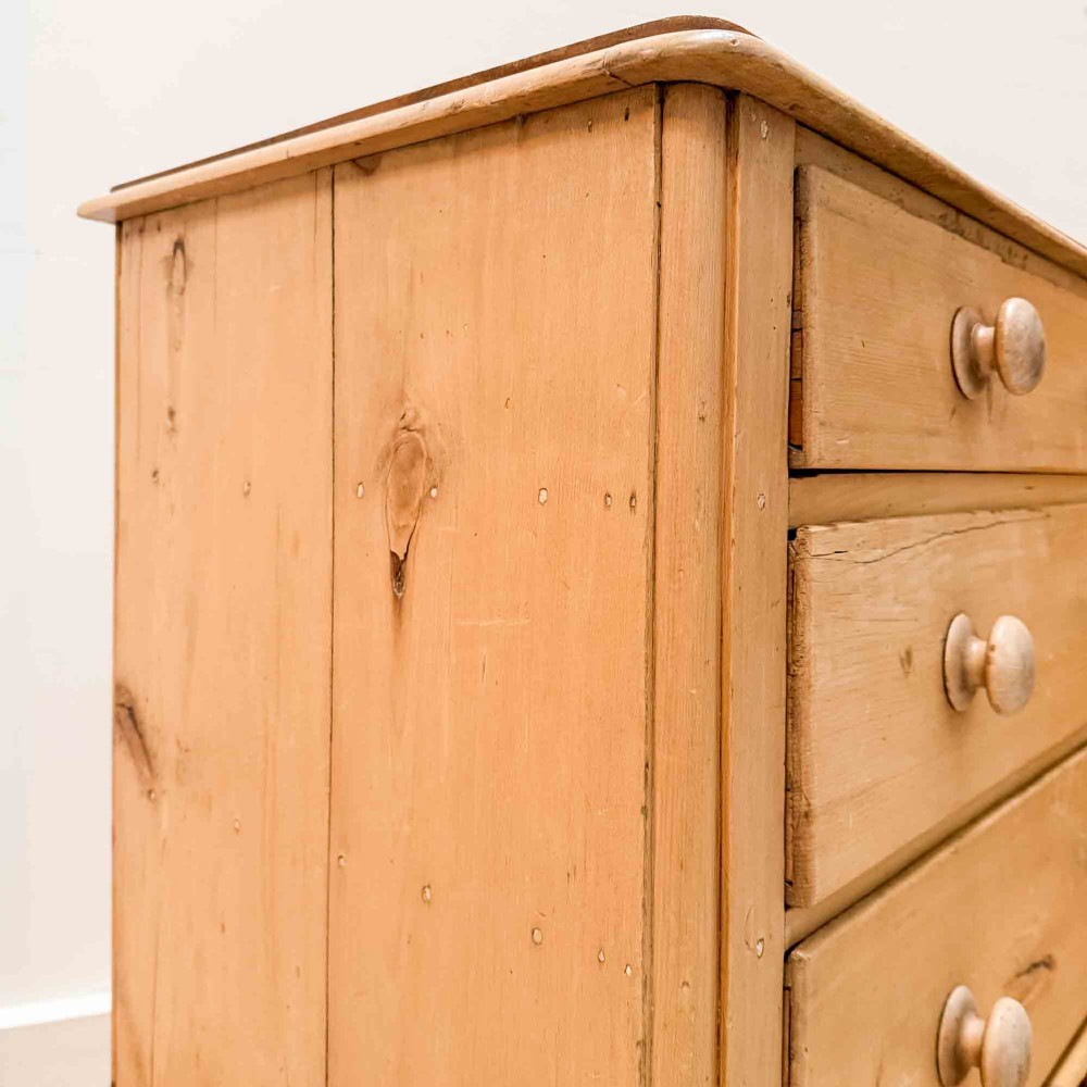 A natural light pine chest of drawers featuring three full-width drawers with turned wooden knobs, rounded front column edges, and turned bun feet. View IX