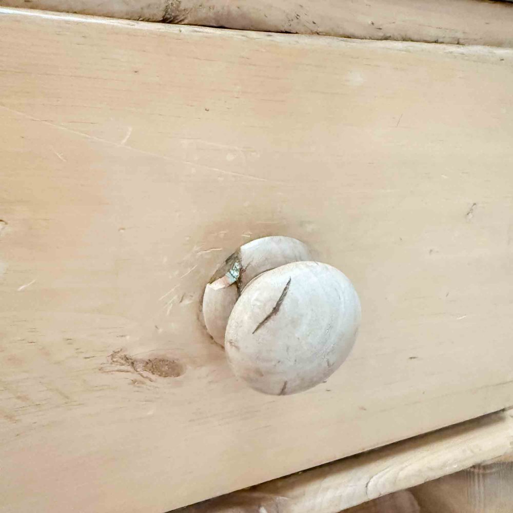 A natural light pine chest of drawers featuring three full-width drawers with turned wooden knobs, rounded front column edges, and turned bun feet. View XI