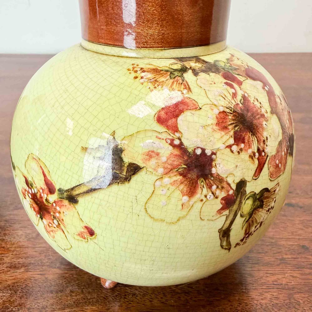 A pair of round pale green ceramic vases with hand-painted pink cherry blossom branches, dark brown collars, and small tripod feet. View VI