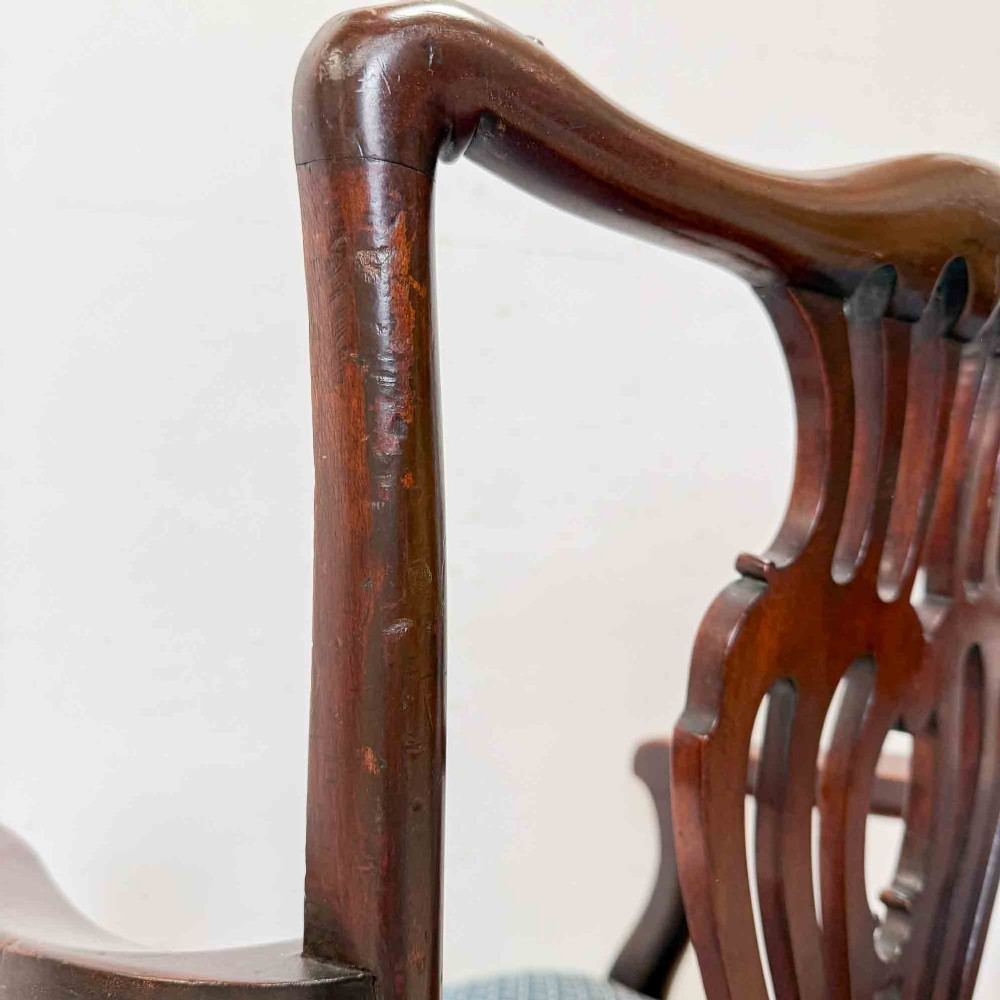 A pair of dark mahogany armchairs featuring carved pierced back splats, shaped arms, and blue patterned upholstered seats. View XI