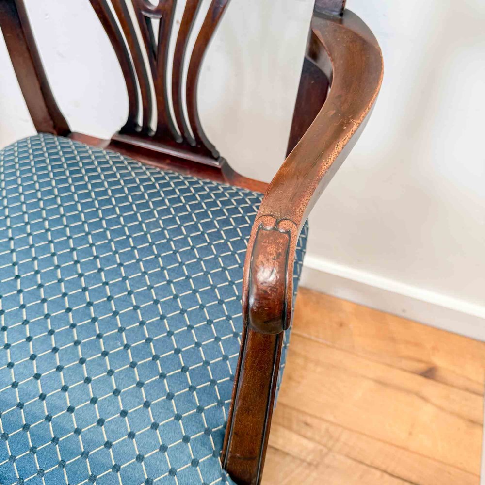 A pair of dark mahogany armchairs featuring carved pierced back splats, shaped arms, and blue patterned upholstered seats. View XII