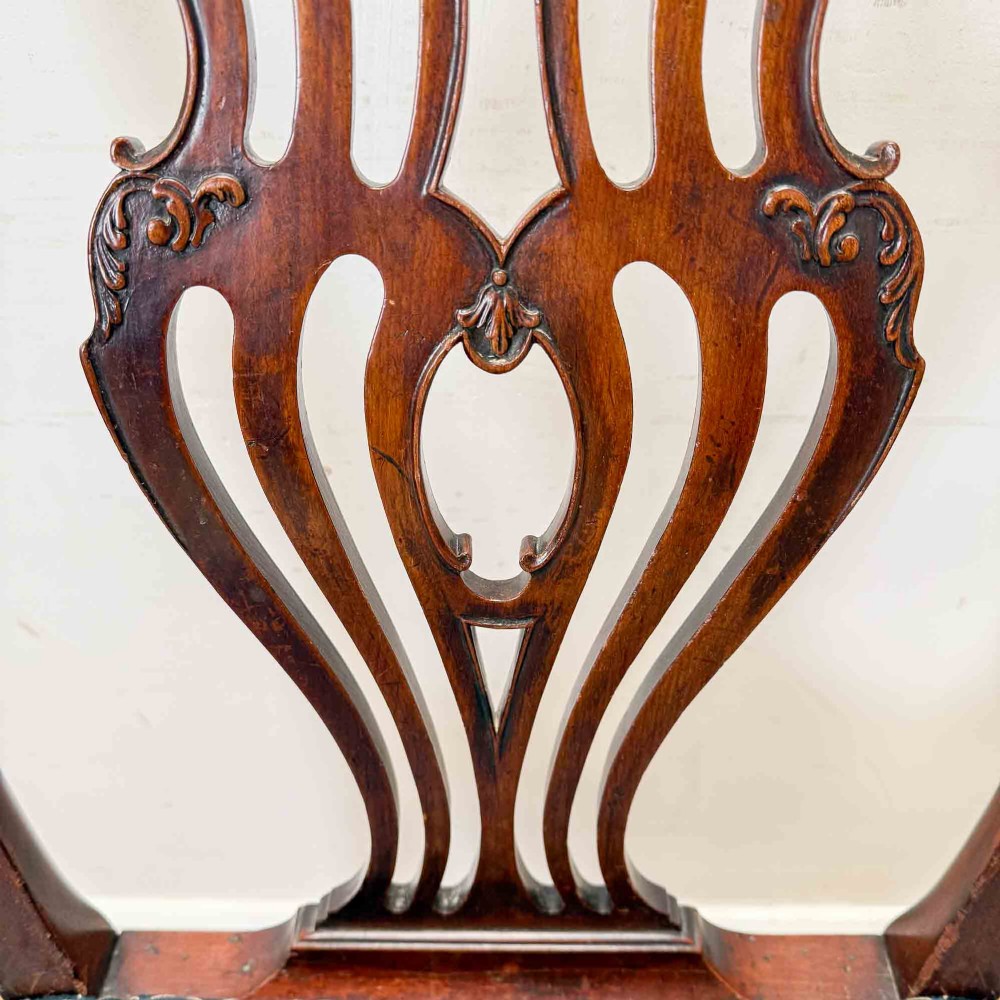 A pair of dark mahogany armchairs featuring carved pierced back splats, shaped arms, and blue patterned upholstered seats. View XIII