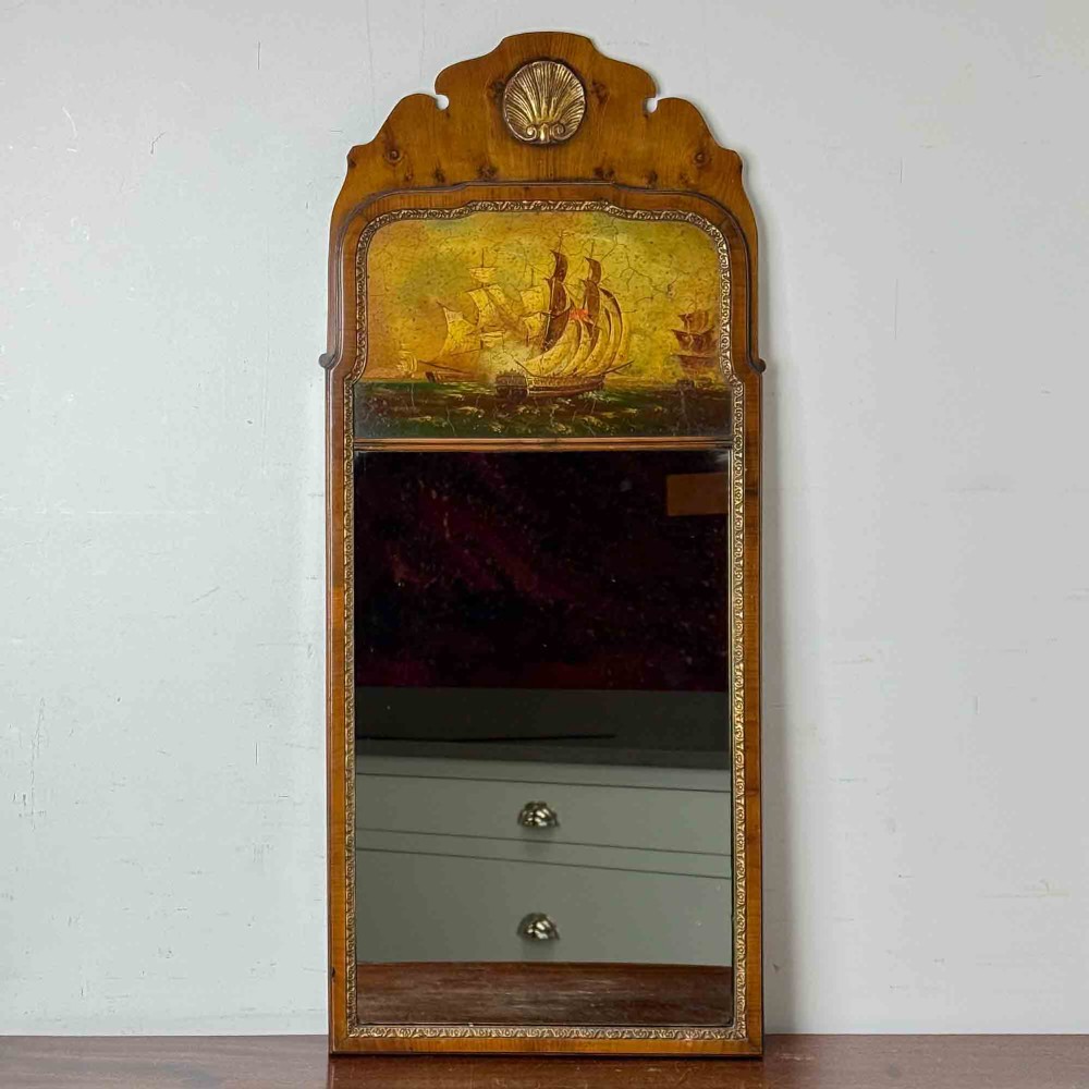A tall Queen Anne Revival yew wood wall mirror featuring a carved shell crest at the top, an upper panel painted with a sailing ship maritime scene, and a rectangular glass mirror below. View III