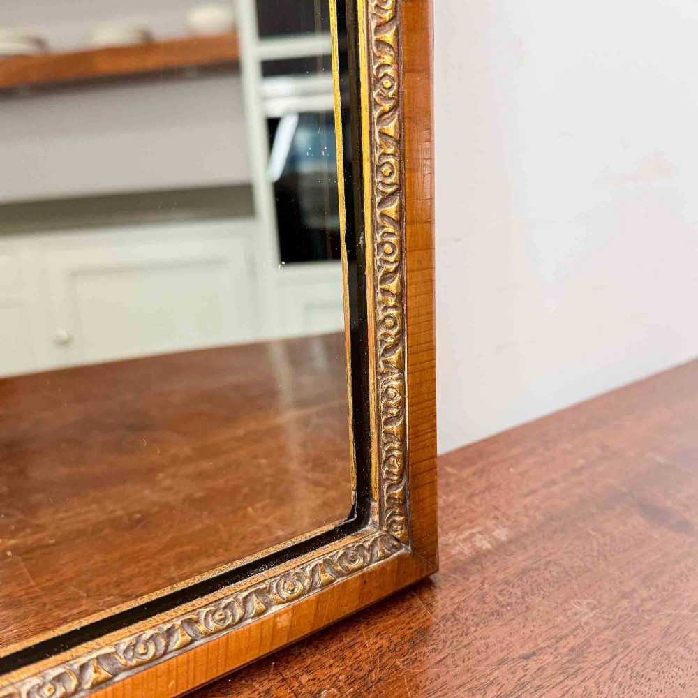 A tall Queen Anne Revival yew wood wall mirror featuring a carved shell crest at the top, an upper panel painted with a sailing ship maritime scene, and a rectangular glass mirror below. View VII