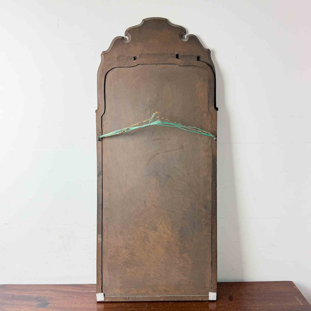 A tall Queen Anne Revival yew wood wall mirror featuring a carved shell crest at the top, an upper panel painted with a sailing ship maritime scene, and a rectangular glass mirror below. View IX