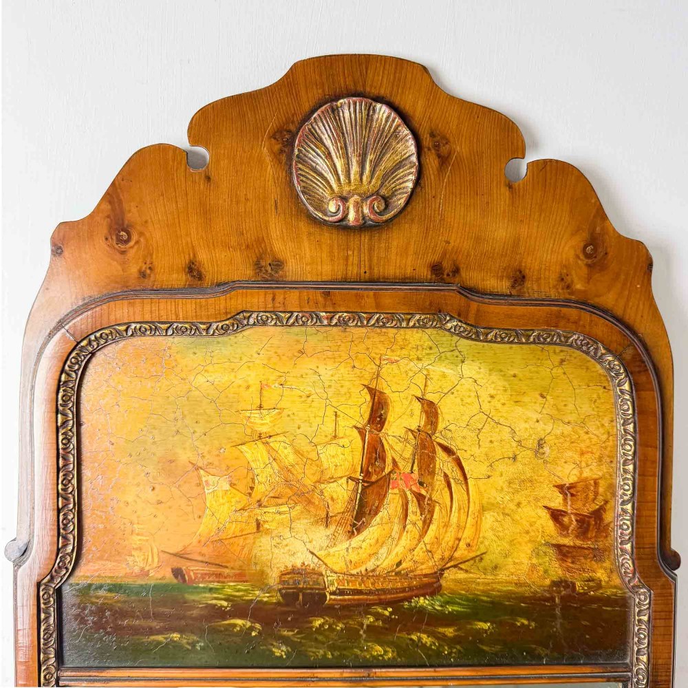 A tall Queen Anne Revival yew wood wall mirror featuring a carved shell crest at the top, an upper panel painted with a sailing ship maritime scene, and a rectangular glass mirror below. View X