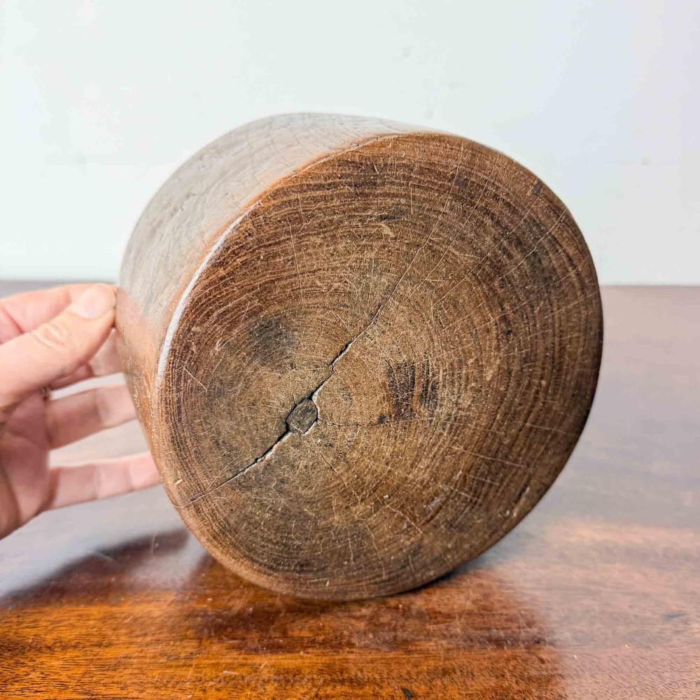 A round hand-carved antique wooden bowl with thick walls and a patinated brown timber surface. View V