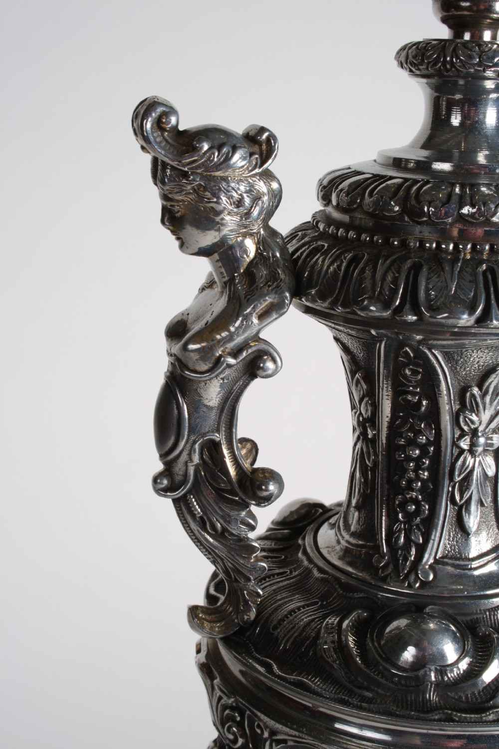 A polished silver-toned spelter table lamp base in the shape of a classical urn with relief carvings and creature handles on a circular marble plinth. View VIII