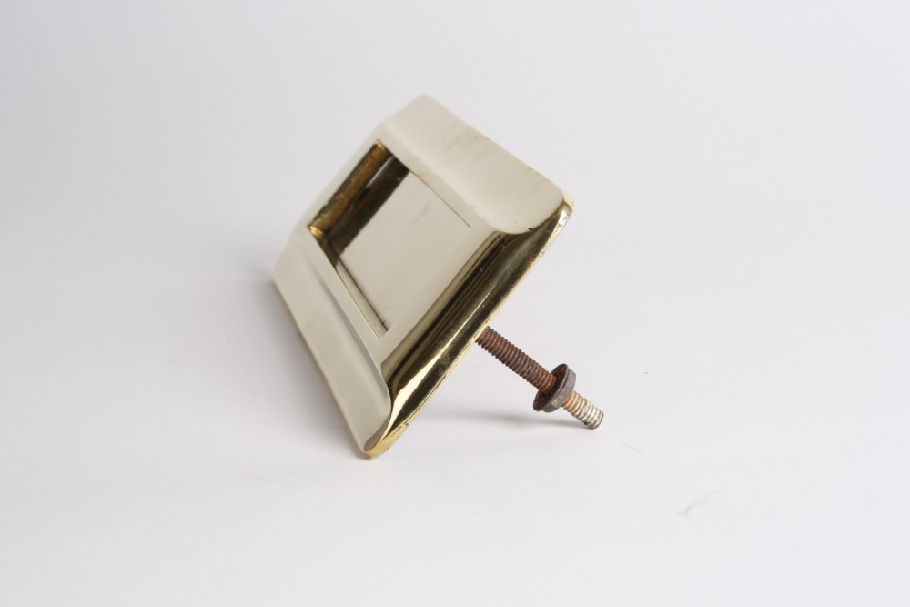 A solid polished brass Art Deco letterbox plate featuring a central rectangular flap within a streamlined bevelled frame. View V