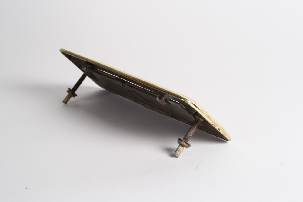A solid polished brass Art Deco letterbox plate featuring a central rectangular flap within a streamlined bevelled frame. View X