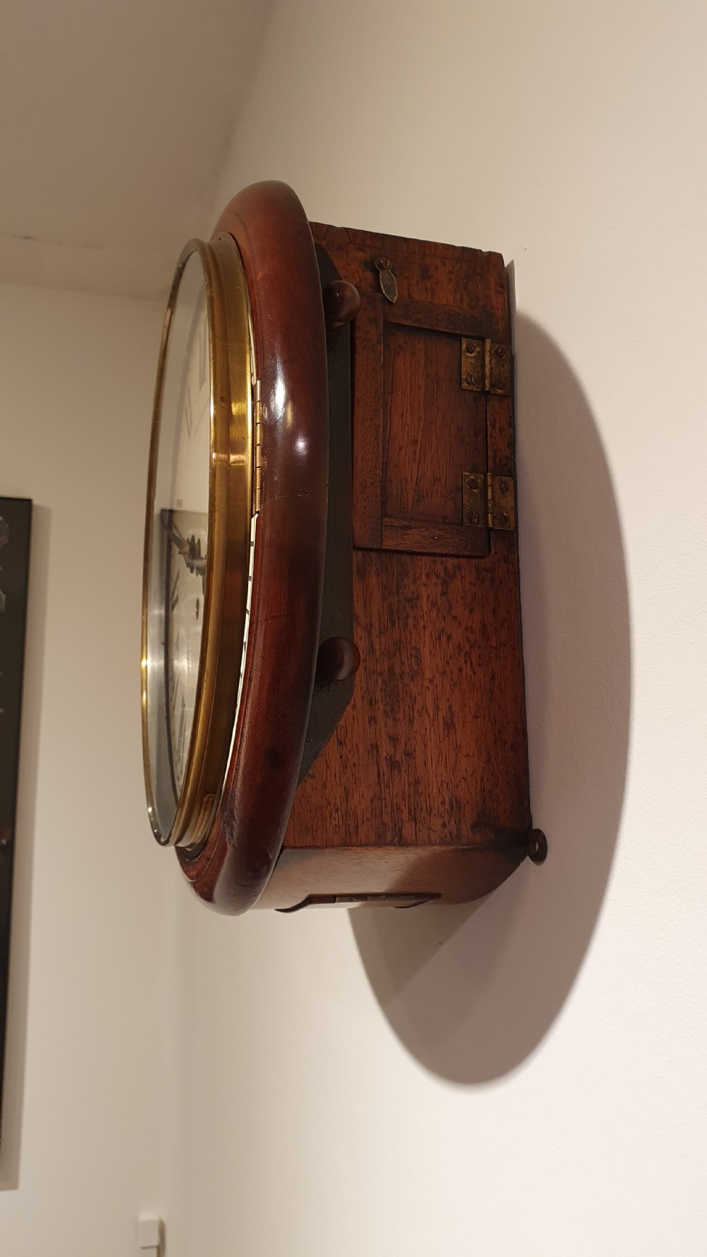 A circular antique mahogany wall clock featuring an off-white dial with black Roman numerals, black hands, and London County Council text. View III