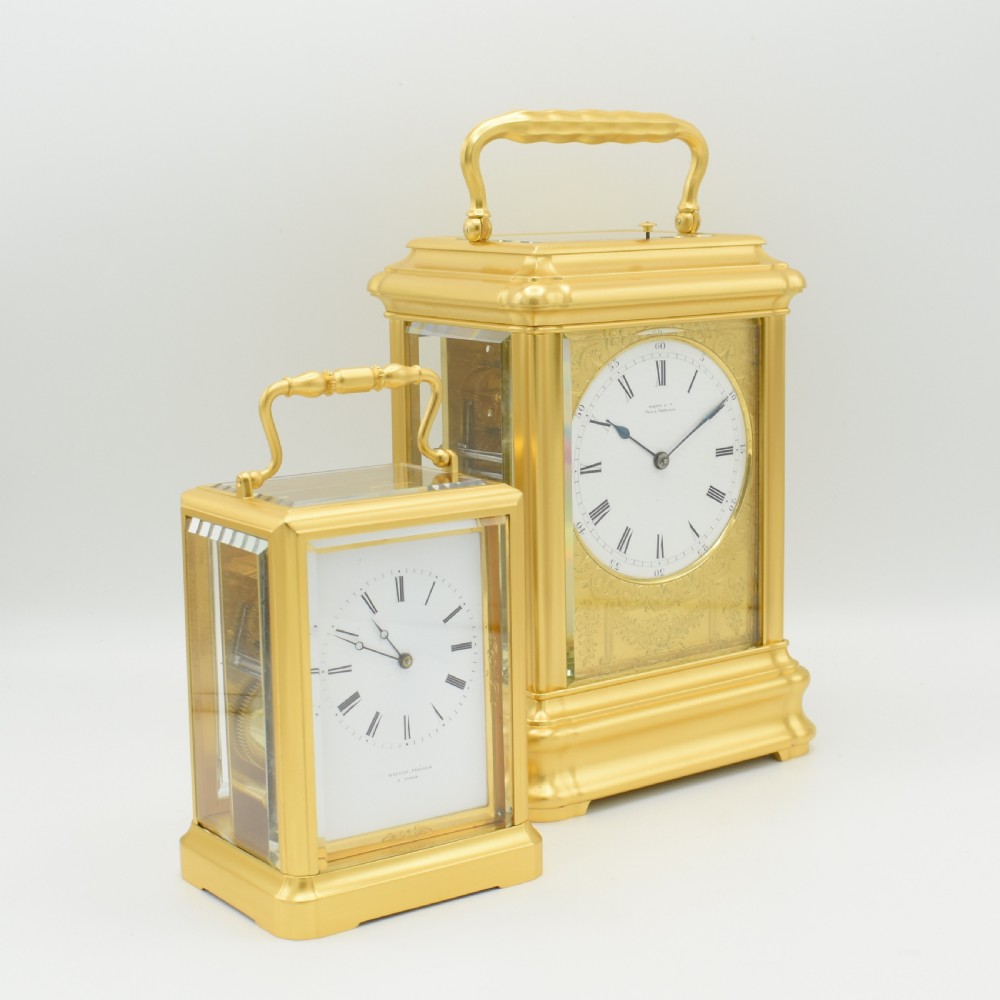 An antique gilt brass carriage clock with an engraved face and white enamel dial housed inside a fitted dark brown leather travelling case with a handle. View VIII