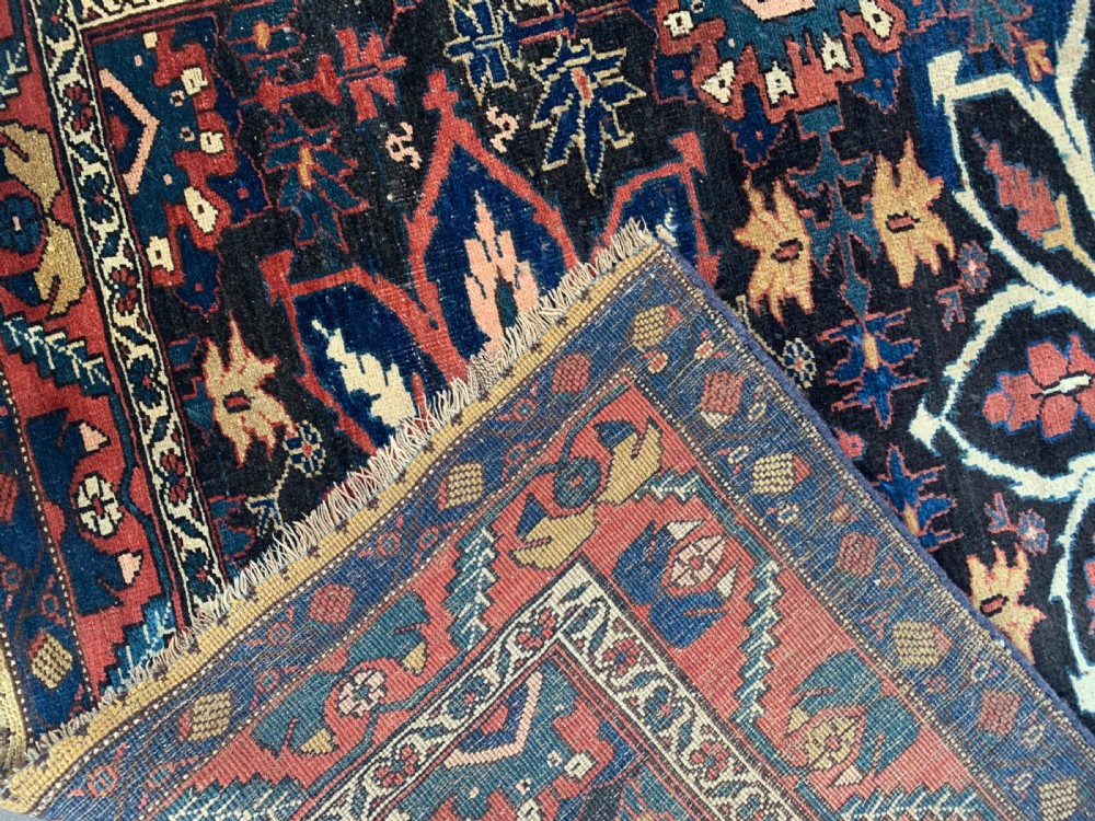 An antique hand-knotted Persian Bidjar long rug featuring a central column of large star rosettes on a navy blue field enclosed within a decorated terracotta border. View VII