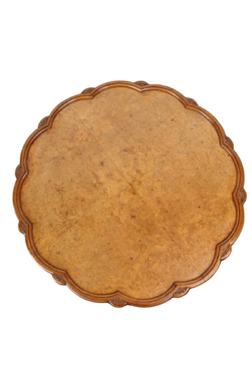 fig 1. A low circular burr walnut coffee table featuring a scalloped pie crust rim and carved cabriole legs with pad feet.