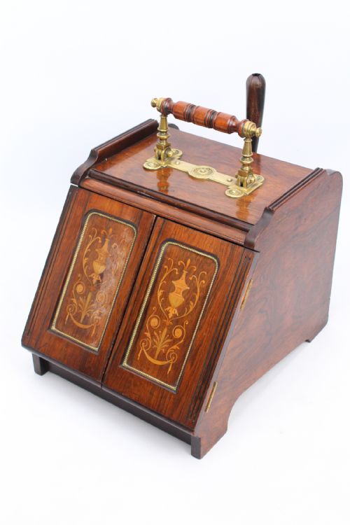 fig 1. A Victorian rosewood metamorphic coal purdonium featuring urn marquetry inlays on front doors and a turned brass handle on top.