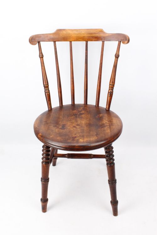 fig 1. A pair of warm brown wooden kitchen chairs featuring spindle backs, turned legs, and solid timber seats.
