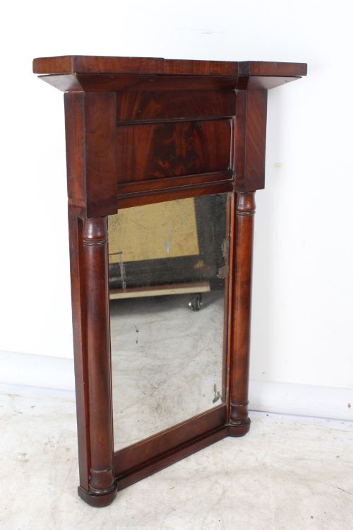 fig 1. A small rectangular Regency mahogany pier mirror featuring an overhanging upper cornice, side column supports, and foxed glass.
