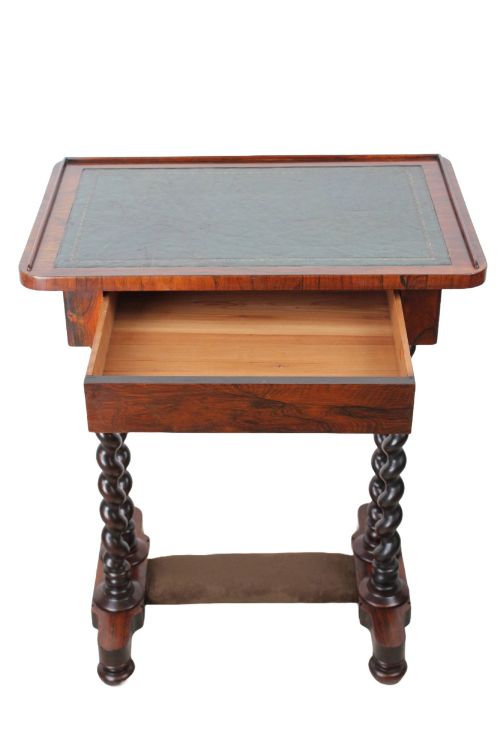 fig 1. A small Regency rosewood side table featuring an inset green leather top with gold leaf tooling, supported by twin barley twist columns on a trestle base.