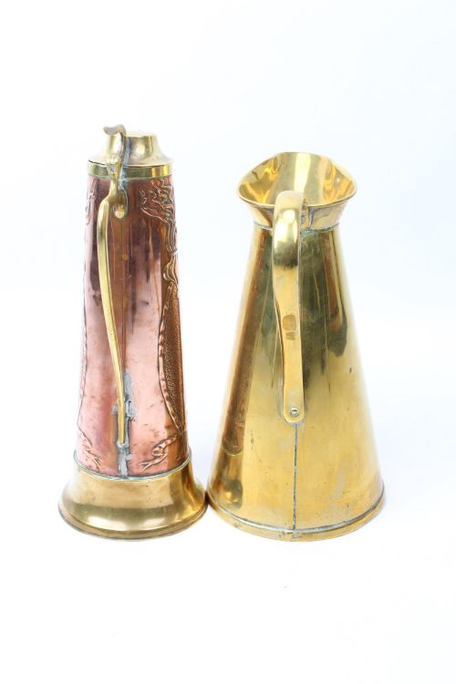 fig 1. A pair of antique metal jugs, one crafted from repousse copper with brass fittings and a hinged lid alongside a tapered solid brass pitcher.