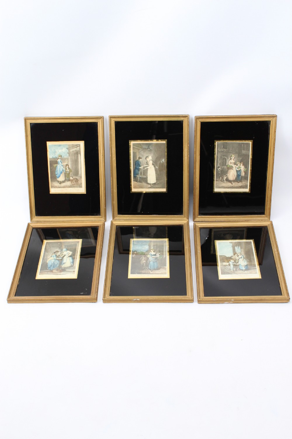 A set of six framed antique prints depicting Francis Wheatleys Cries of London series with black glass mounts and gilded wooden frames.