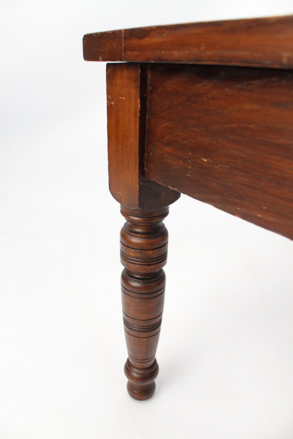An Edwardian carved oak luggage stand with relief floral carving along the open top frame and turned wooden legs. View X