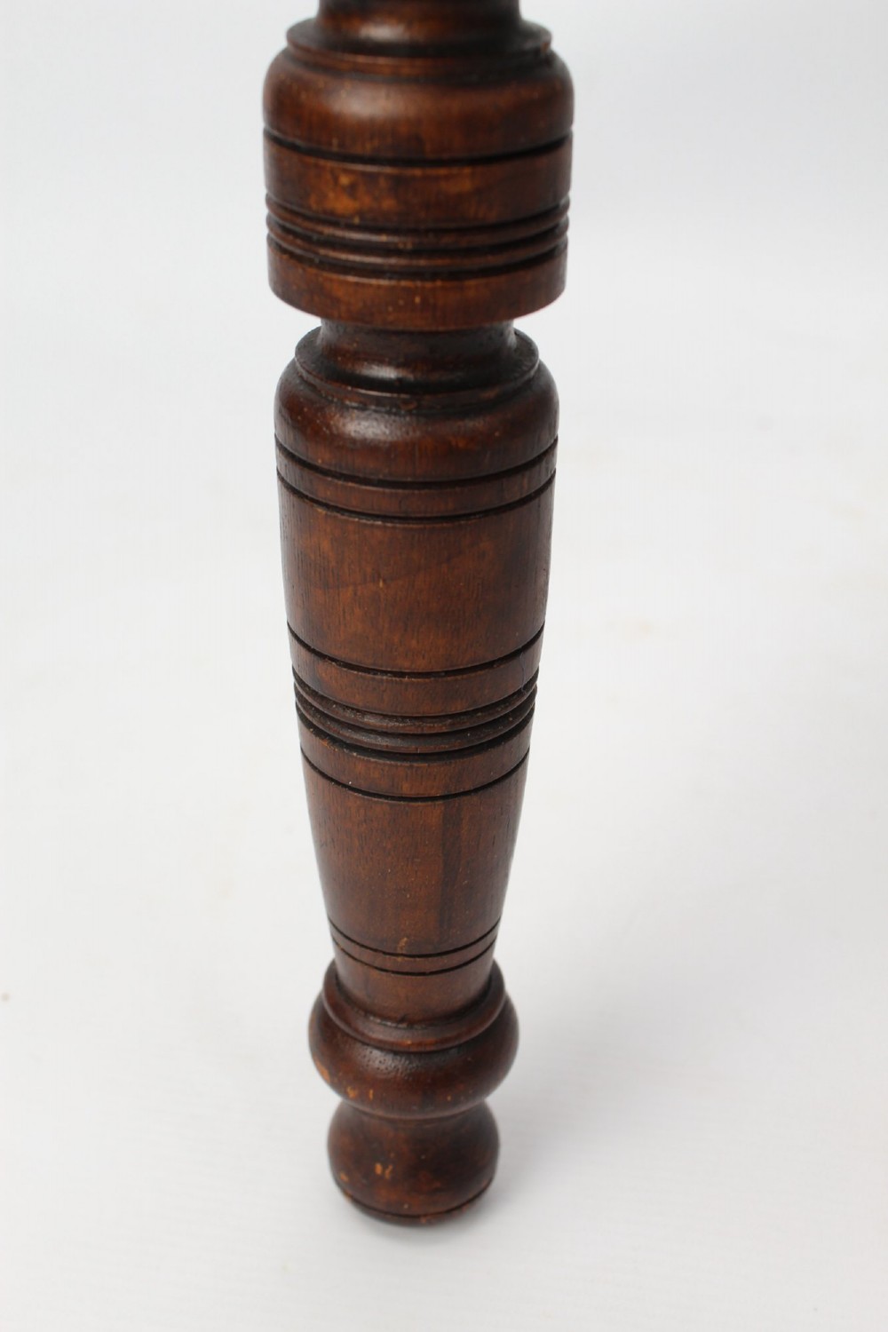 An Edwardian carved oak luggage stand with relief floral carving along the open top frame and turned wooden legs. View XI